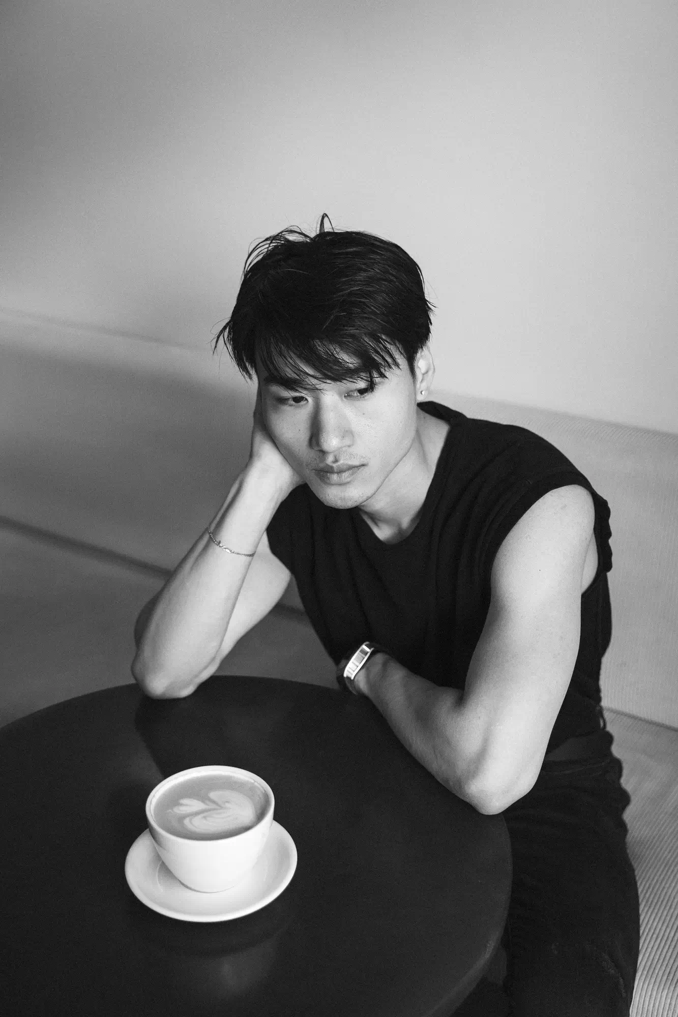 a man sits alone and drinks latte